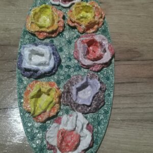 Knitted flowers from wool colored sculptural ceramic  plate,  handmade.