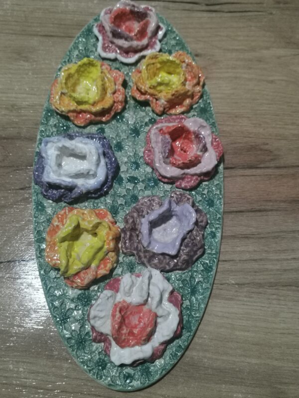 Knitted flowers from wool colored sculptural ceramic  plate,  handmade.